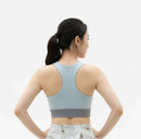 Back view of a model wearing the BELVYNN Signature Women's Blue Top in a minimalist studio, featuring a refined fit and luxury performance fabric.