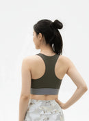Back view of a model wearing the BELVYNN Signature Women's Green Top in a minimalist studio, featuring a refined fit and luxury performance fabric.