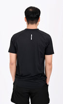 Back view pose of a person wearing a BELVYNN premium Black t-shirt and black shorts on a white background