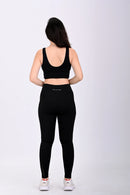 Back view pose of a person wearing a BELVYNN premium black athletic outfit with visible brand logo on a white background