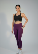 Close-up of BELVYNN Cropped Asian Fit Purple Leggings on a model, showing the side pocket, the precision ankle hem and high-density technical fabric.