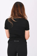 Close up back view of a person wearing a BELVYNN premium black t-shirt and black shorts on a white background