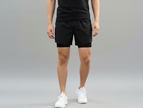 Close up front view of a male model wearing BELVYNN Men’s premium 2-layer Essential Gym Shorts in black with a 5-inch pro-inseam, optimized for the Asian athlete’s mobility and fit.