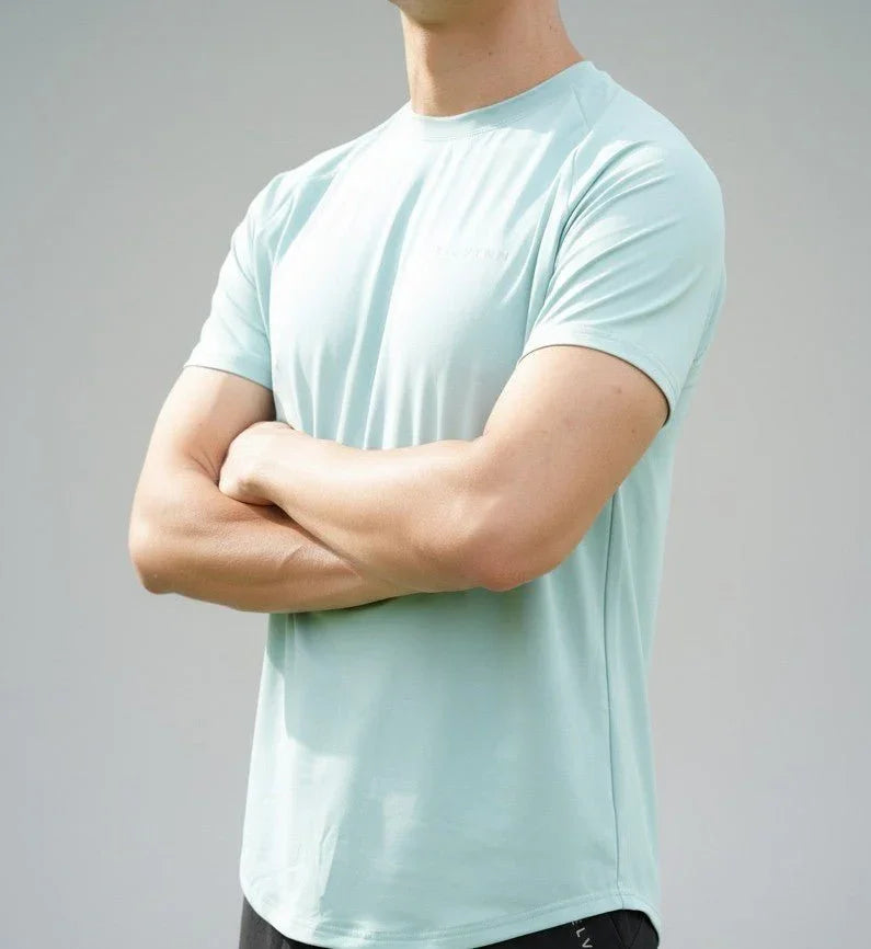Close up shot of male athlete wearing the BELVYNN Men’s Performance T-shirt, highlighting the V-taper silhouette and climate-tech moisture management.