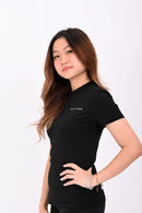 Close up side view of a person wearing a BELVYNN premium black t-shirt and black shorts on a white background