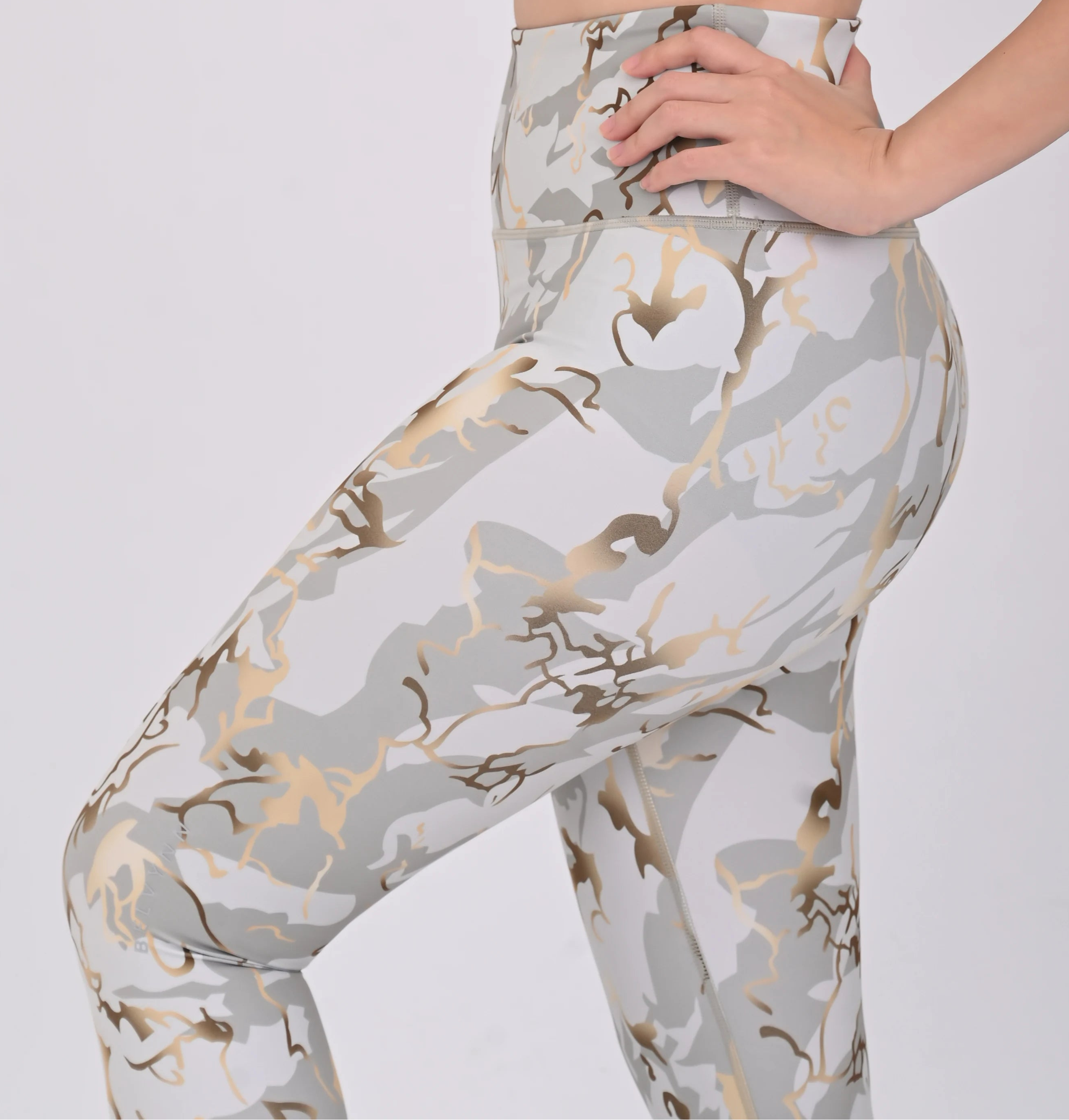 Close up view of a woman wearing a BELVYNN premium printed leggings with a white background