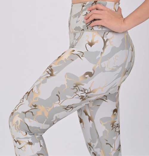 Close up view of a woman wearing a BELVYNN premium printed leggings with a white background