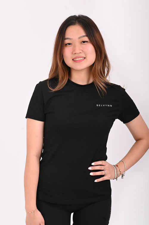 Front view of a person wearing a BELVYNN premium black t-shirt and black shorts on a white background