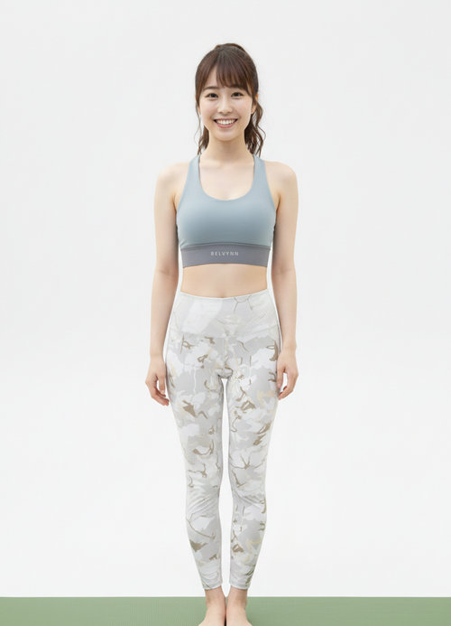 Full view of a model wearing the BELVYNN Signature Women's Top and pants in a minimalist studio, featuring a refined fit and luxury performance fabric.