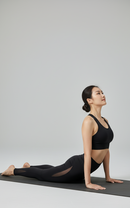 In studio yoga pose view of BELVYNN Women’s Long-Inseam Leggings in charcoal, featuring high-rise support and premium 40% Spandex stability.