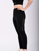 Person wearing a BELVYNN premium black leggings with mesh panels on a light gray background