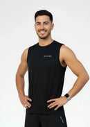 Person wearing a BELVYNN premium black tank top and black pants on a white background