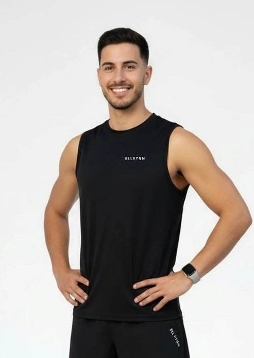 Person wearing a BELVYNN premium black tank top and black pants on a white background