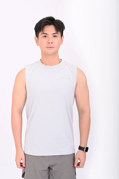 Person wearing a BELVYNN premium gray tank top and gray pants on a white background
