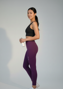 Side view of BELVYNN Cropped Asian Fit Purple Leggings on a model, showing the precision ankle hem and high-density technical fabric.
