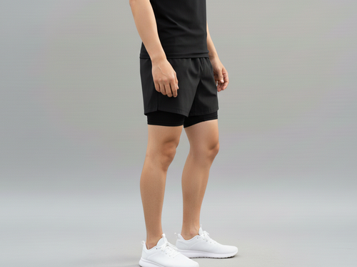 Side view of a male model wearing BELVYNN Men’s premium 2-layer Essential Gym Shorts in Black with a 5-inch pro-inseam, optimized for the Asian athlete’s mobility and fit.