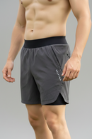 Side view of a male model wearing BELVYNN Men’s premium 2-layer Essential Gym Shorts in Gray with a 5-inch pro-inseam, optimized for the Asian athlete’s mobility and fit.