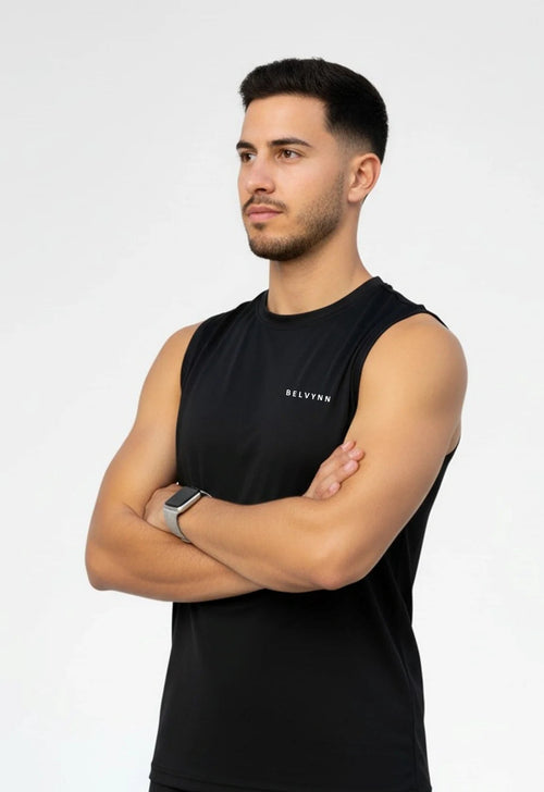 Side view of a person wearing a BELVYNN premium black tank top and black pants on a white background