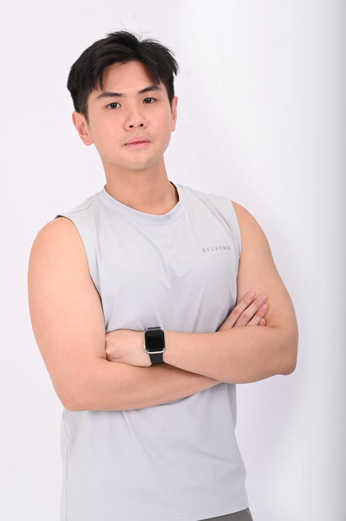 Side view of a person wearing a BELVYNN premium gray tank top and gray pants on a white background
