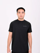 Standing pose of a person wearing a BELVYNN premium Black t-shirt and black shorts on a white background