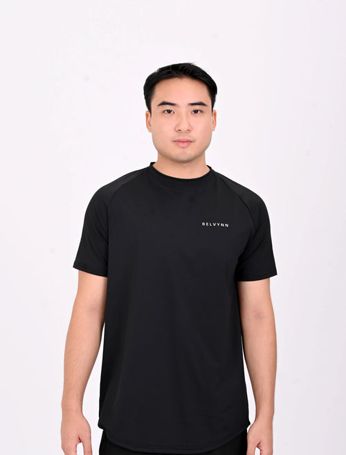 Standing pose of a person wearing a BELVYNN premium Black t-shirt and black shorts on a white background