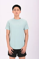 Standing pose of a person wearing a BELVYNN premium teal green t-shirt and black shorts on a white background