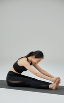 In studio yoga sitting pose view of BELVYNN Women’s Long-Inseam Leggings in charcoal, featuring high-rise support and premium 40% Spandex stability.